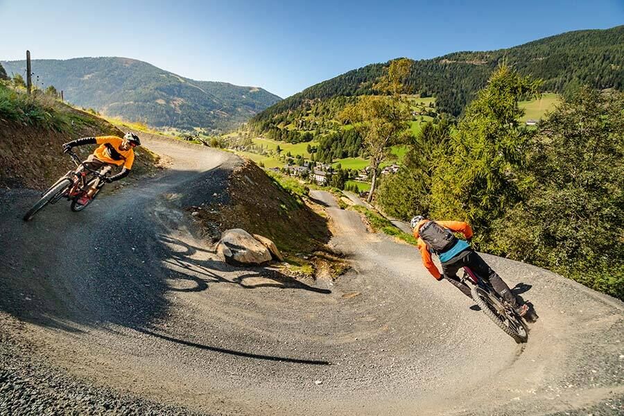 Two mountain bikers ride down the Flow Country Trail in Carinthia