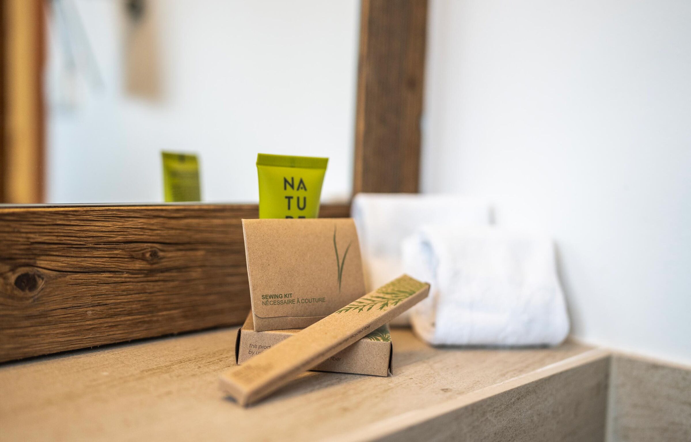 Natural products for the bathroom stand on a wooden shelf.