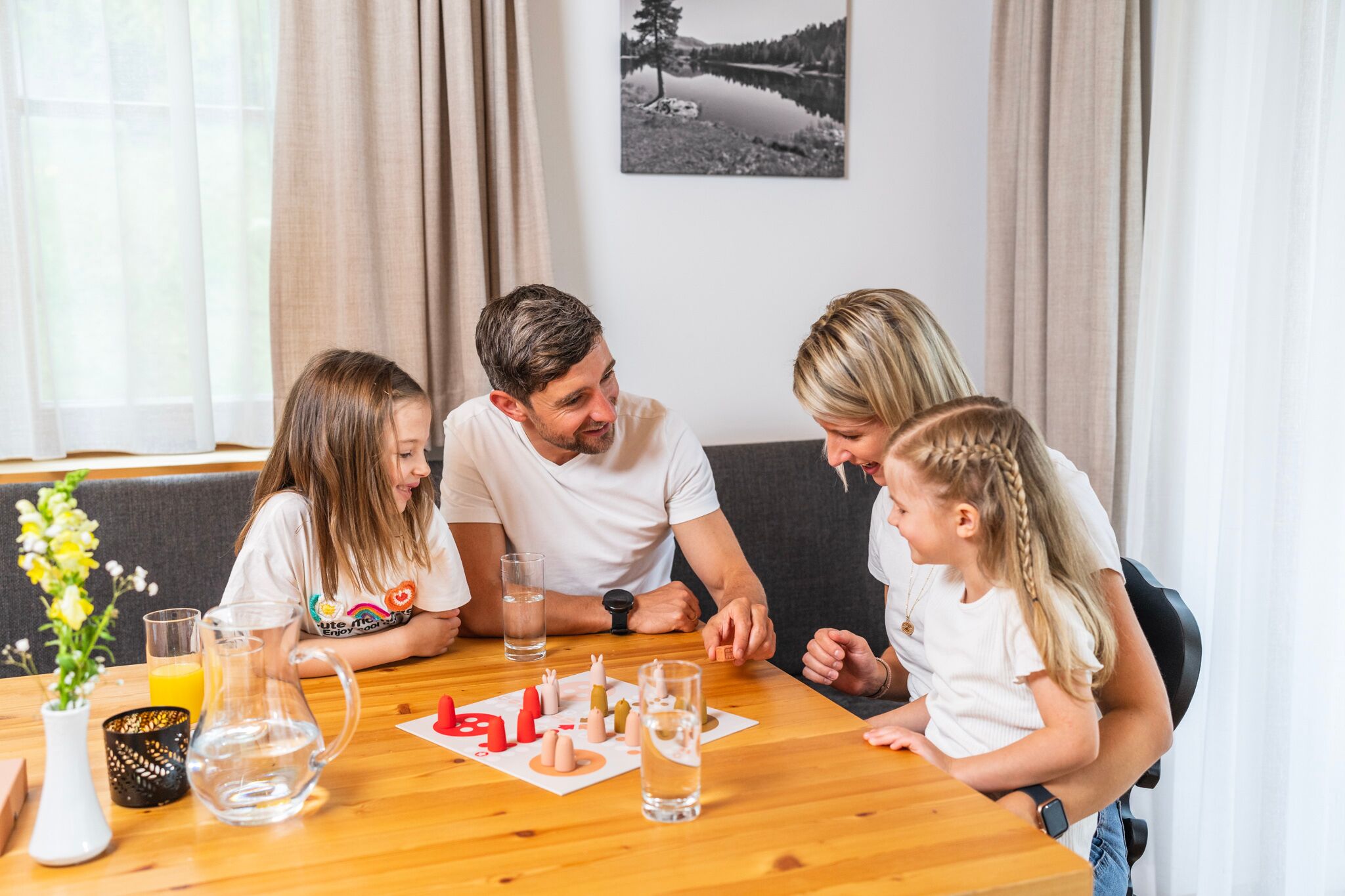 A family of four playing a board game.