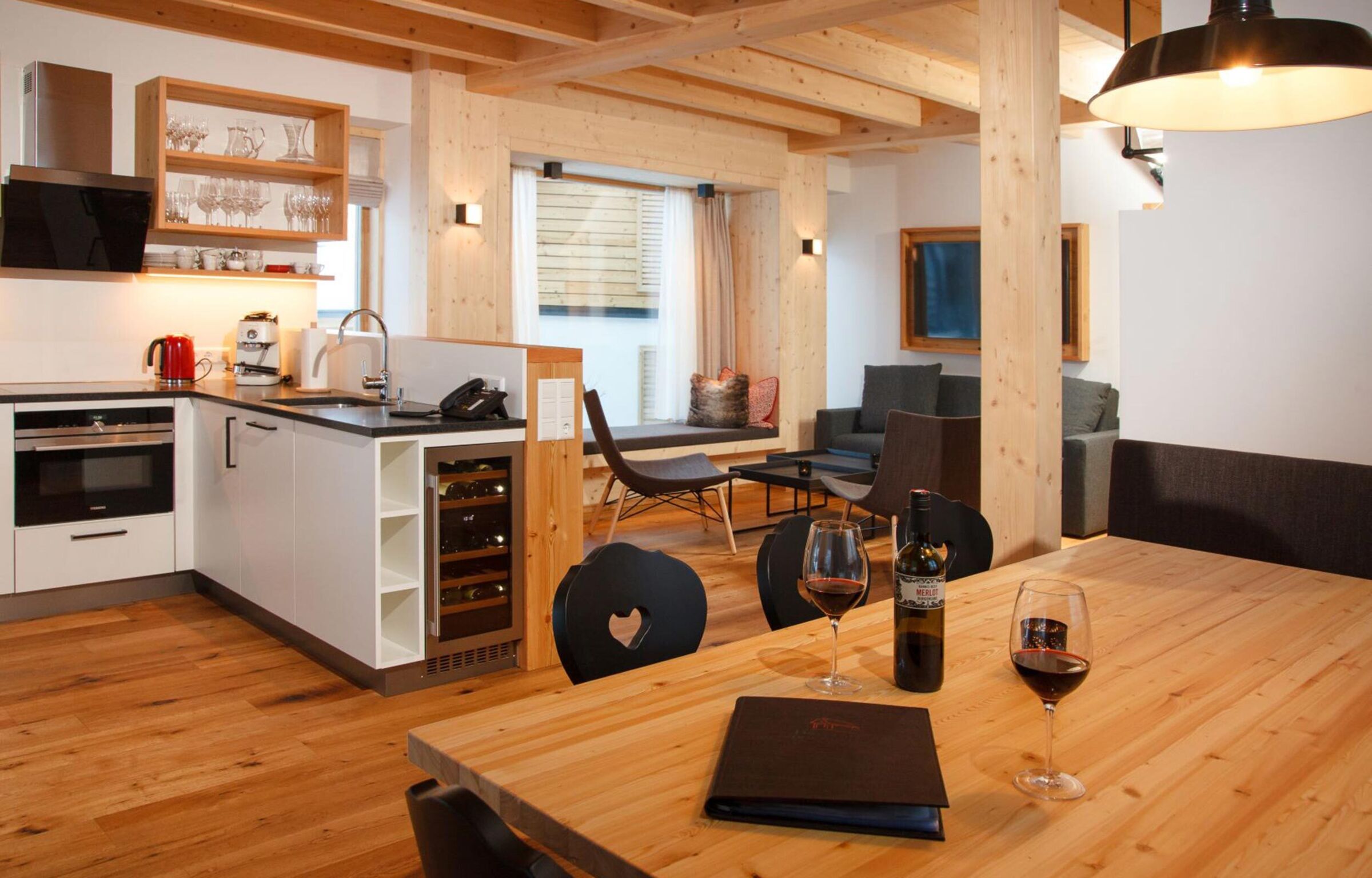Modern and large kitchen with dining area and living room in the Trattlers Hof-Chalets in Carinthia