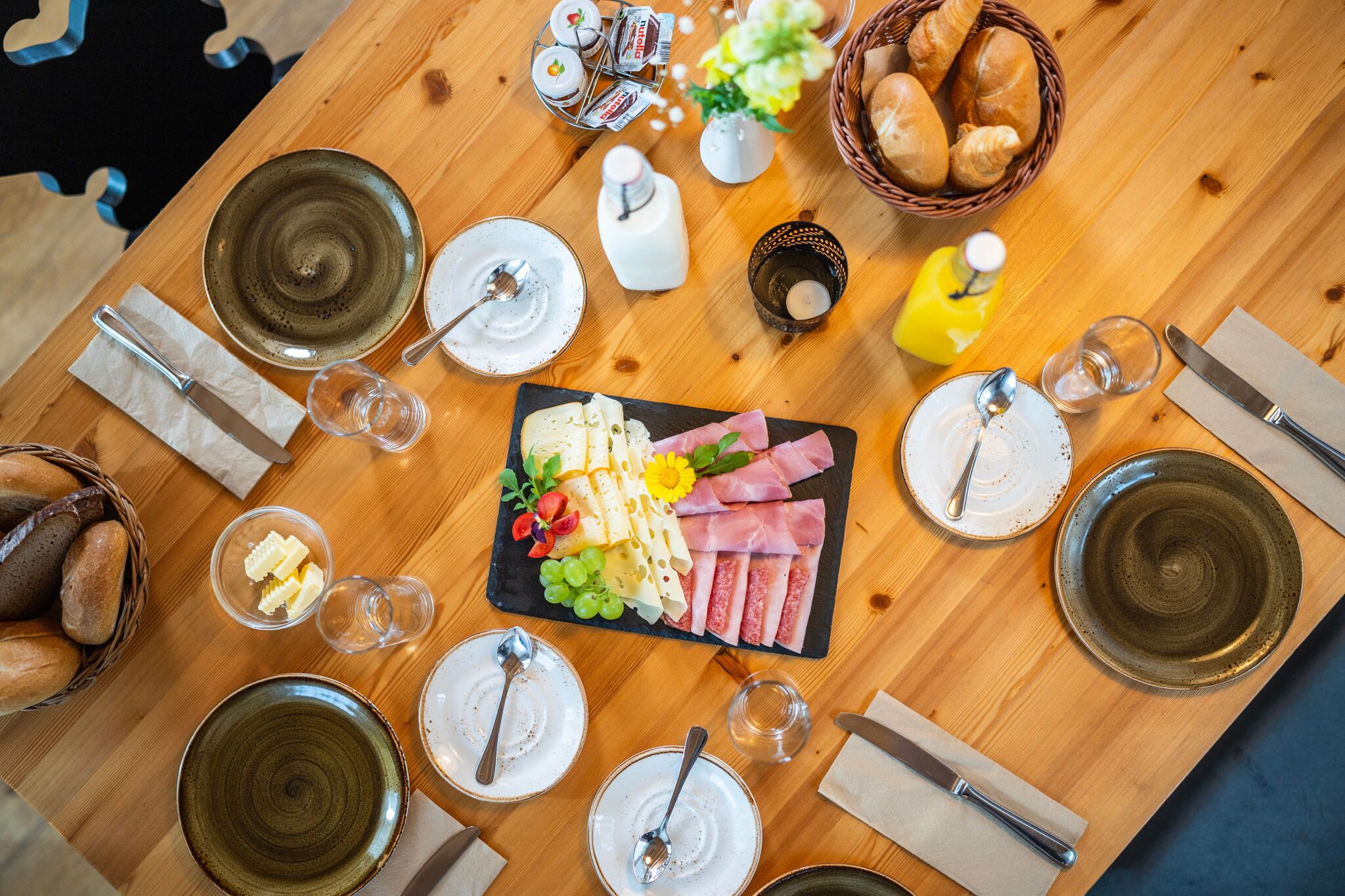 A fully laid breakfast table with all kinds of delicacies.