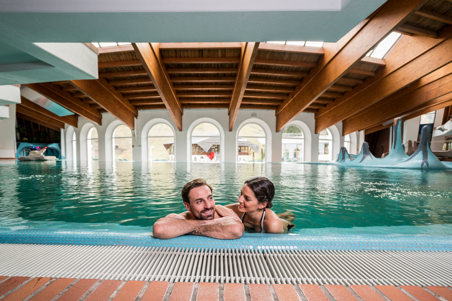 A couple swimming in the Römerbad thermal baths.